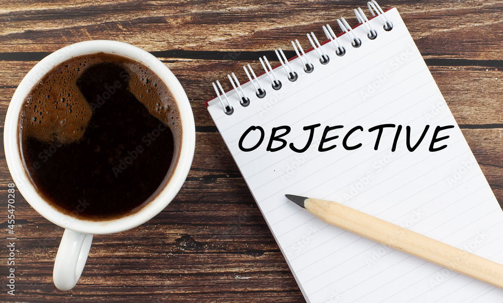 Poster objective text on notebook with coffee on wooden background