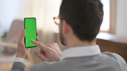 Rear View of Man using Smartphone with Chroma Key Screen