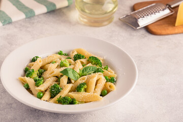 Pasta with green peas, broccoli and parmesan cheese.