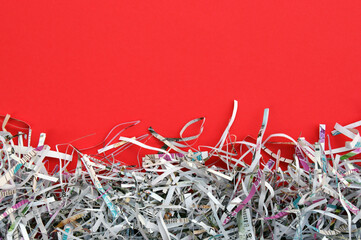 The white shredded paper on red background.