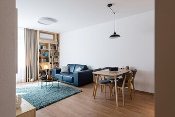 Dining table and living room of modern apartment