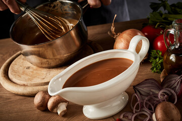 Sauce boat filled with rich brown spicy gravy