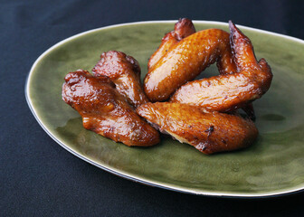 local charcoal bbq grilled honey golden chicken wing in plate on dark grey wood table asian dim sum halal food restaurant cuisine banquet menu for cafe