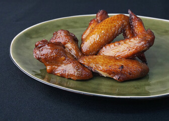 bbq grilled honey golden chicken wing on dark grey wood background fast food halal menu