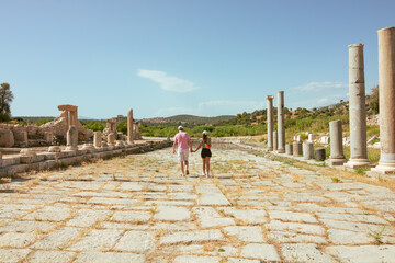 Couples walking in the harbor street of Patara Ancient City in Antalya Turkey. Tourists in Patara....