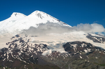 Fototapeta na wymiar Perspective of caucasian snow mountain or volcano Elbrus. Landscape view - the highest peak of Europe