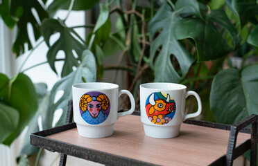 Mid-century modern porcelain mug with animal pattern isolated, flying on white background