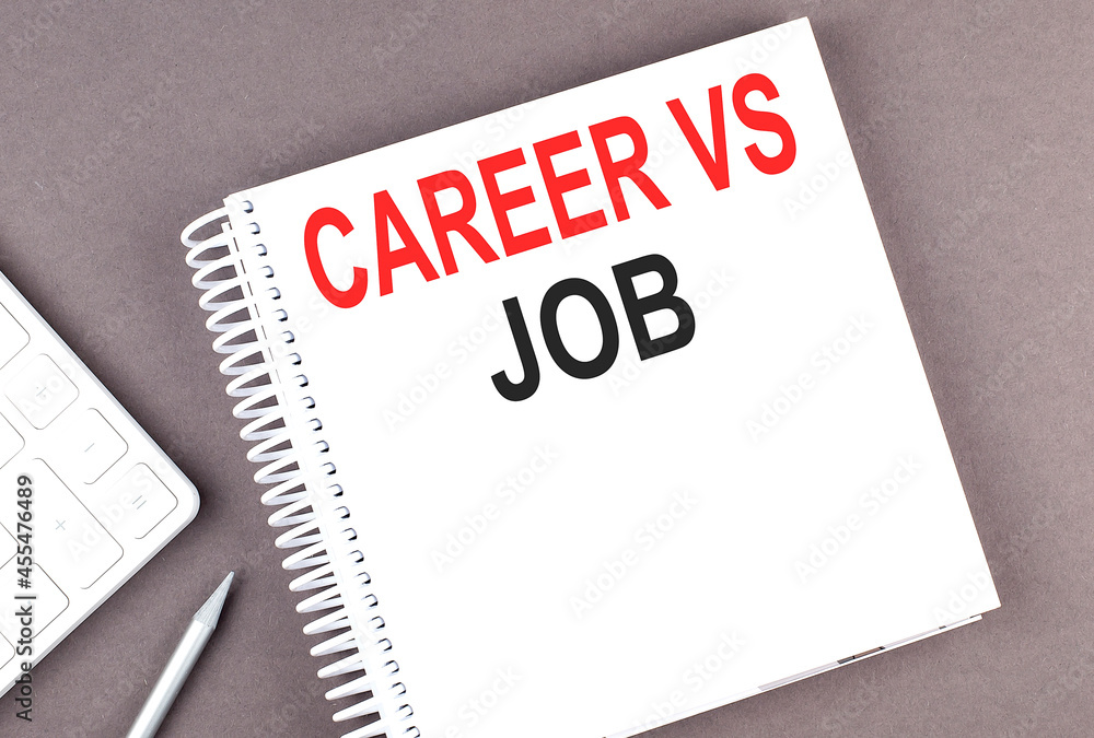 Poster career vs job text on the notebook with calculator and pen