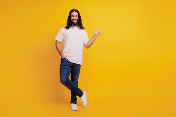 Fototapeta na wymiar Portrait of promoter positive confident guy indicate finger empty space on yellow background