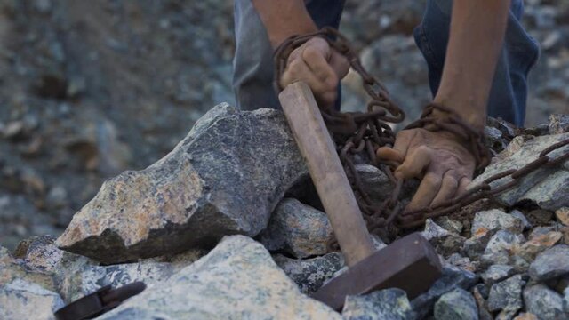 The slave freed himself from the chains that bind his hands