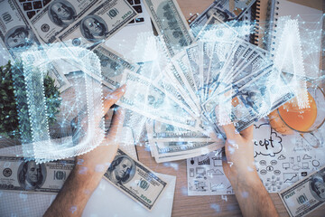 Multi exposure of technology drawing hologram and us dollars bills and man hands. Data concept
