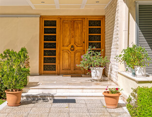 contemporary family house facade and corridor to wooden door, Athens Greece