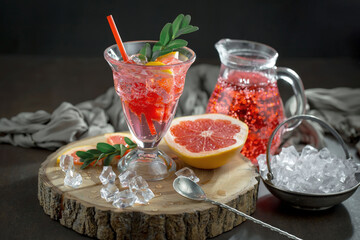 Fruit cocktail, in a glass with natural healthy fruits on a table with kitchen accessories.