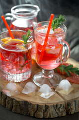 Fruit cocktail, in a glass with natural healthy fruits on a table with kitchen accessories.