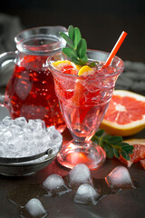 Fruit cocktail, in a glass with natural healthy fruits on a table with kitchen accessories.