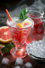 Fruit cocktail, in a glass with natural healthy fruits on a table with kitchen accessories.