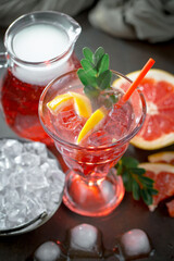 Fruit cocktail, in a glass with natural healthy fruits on a table with kitchen accessories.