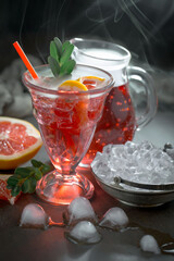 Cocktail in a glass with fruit on an old background.