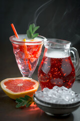 Fruit cocktail, in a glass with natural healthy fruits on a table with kitchen accessories.