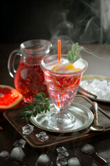 Cocktail in a glass with fruit on an old background.