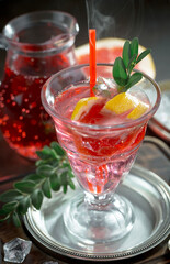 Fruit cocktail, in a glass with natural healthy fruits on a table with kitchen accessories.