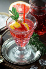Cocktail in a glass with fruit on an old background.
