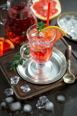 Fruit cocktail, in a glass with natural healthy fruits on a table with kitchen accessories.