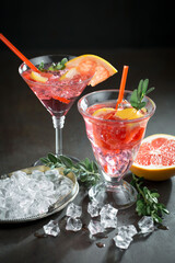 Fruit cocktail, in a glass with natural healthy fruits on a table with kitchen accessories.