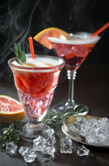 Fruit cocktail, in a glass with natural healthy fruits on a table with kitchen accessories.