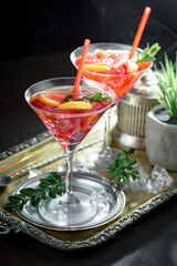 Fruit cocktail, in a glass with natural healthy fruits on a table with kitchen accessories.