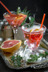 Cocktail in a glass with fruit on an old background.