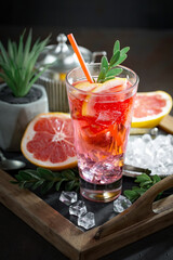 Fruit cocktail, in a glass with natural healthy fruits on a table with kitchen accessories.