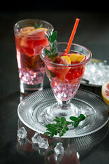 Fruit cocktail, in a glass with natural healthy fruits on a table with kitchen accessories.