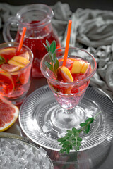 Cocktail in a glass with fruit on an old background.