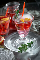 Cocktail in a glass with fruit on an old background.