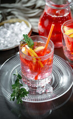 Fruit cocktail, in a glass with natural healthy fruits on a table with kitchen accessories.