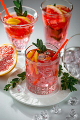 Fruit cocktail, in a glass with natural healthy fruits on a table with kitchen accessories.