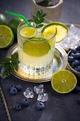 Fruit cocktail, in a glass with natural healthy fruits on a table with kitchen accessories.