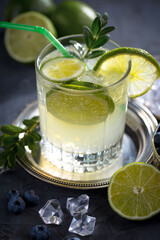 Fruit cocktail, in a glass with natural healthy fruits on a table with kitchen accessories.
