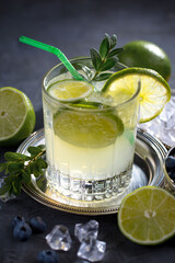 Fruit cocktail, in a glass with natural healthy fruits on a table with kitchen accessories.