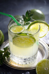 Fototapeta premium Fruit cocktail, in a glass with natural healthy fruits on a table with kitchen accessories.
