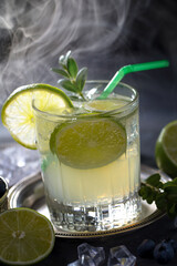 Fruit cocktail, in a glass with natural healthy fruits on a table with kitchen accessories.