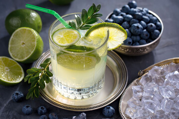Fruit cocktail, in a glass with natural healthy fruits on a table with kitchen accessories.