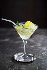 Cocktail in a glass with fruit on an old background.