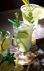 Fruit cocktail, in a glass with natural healthy fruits on a table with kitchen accessories.