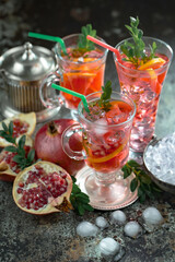 Fruit cocktail, in a glass with natural healthy fruits on a table with kitchen accessories.