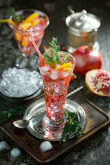 Cocktail in a glass with fruit on an old background.