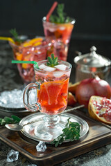 Fruit cocktail, in a glass with natural healthy fruits on a table with kitchen accessories.