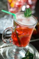 Cocktail in a glass with fruit on an old background.