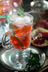 Fruit cocktail, in a glass with natural healthy fruits on a table with kitchen accessories.